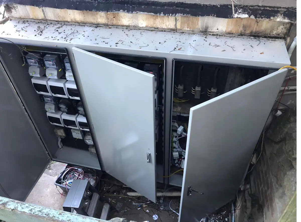 Full run of new meter enclosures open, showing the completed installation