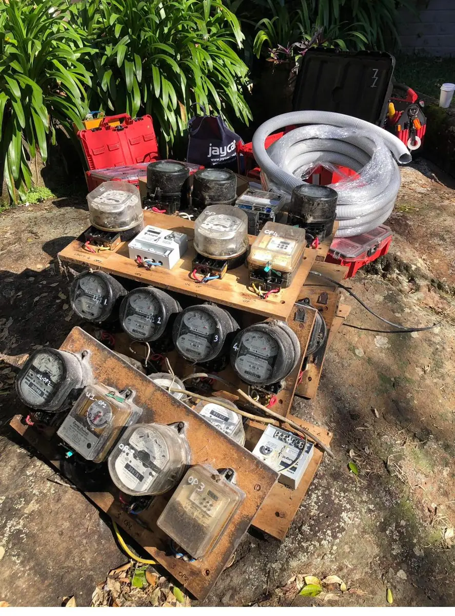 Old timber meter panels removed from the wall and laid out during the upgrade