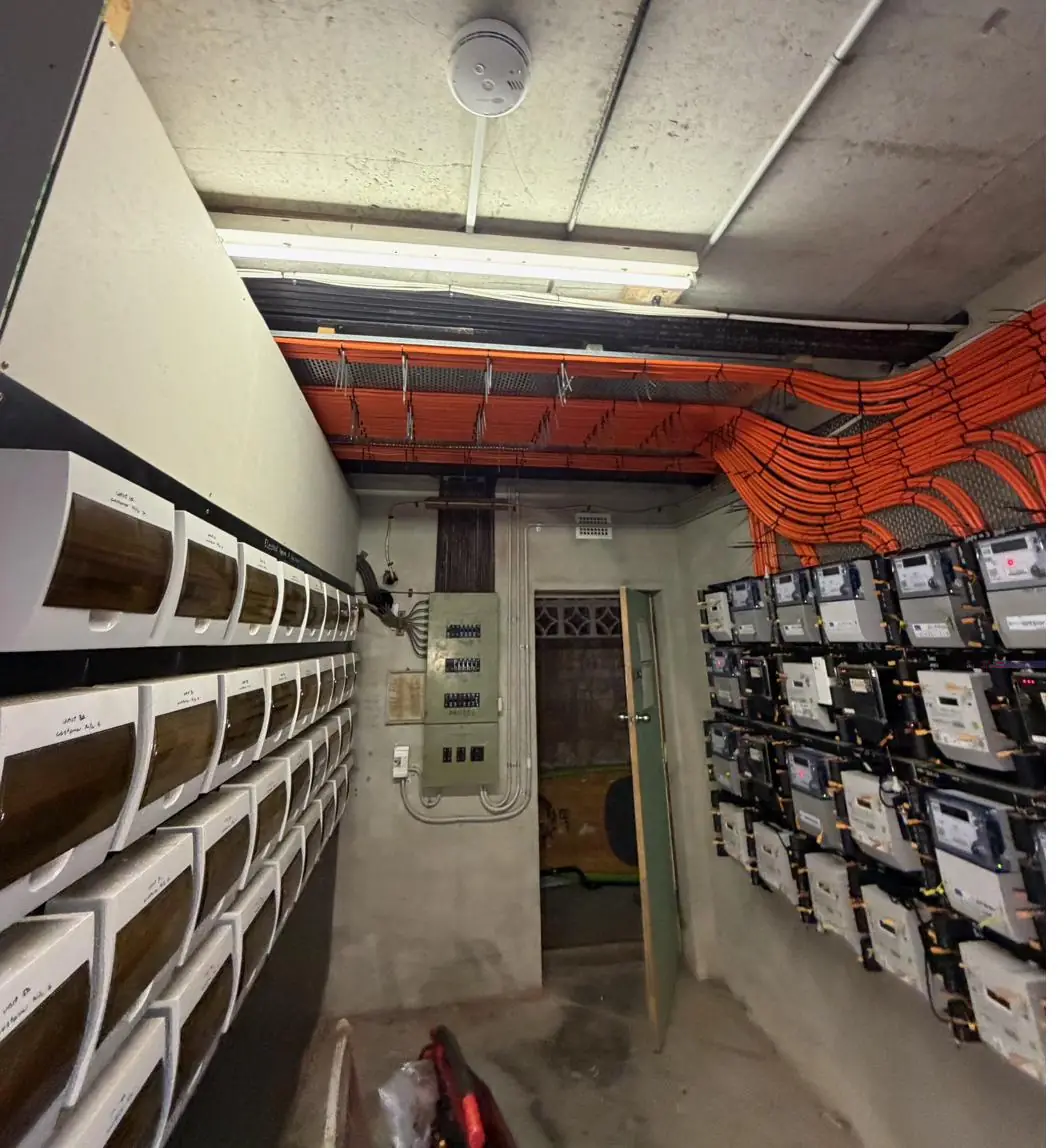 Switchroom showing mailboxes, main switchboard and the new meter wall