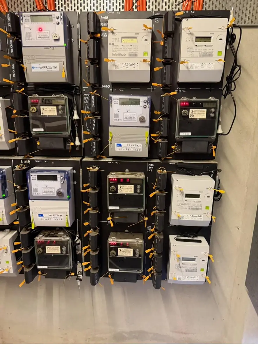 Close-up of installed smart meters, sealed and tagged with unit identification
