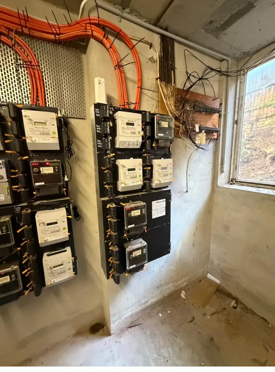 Corner of a switchroom showing new submains, meter panels and the retained legacy supply