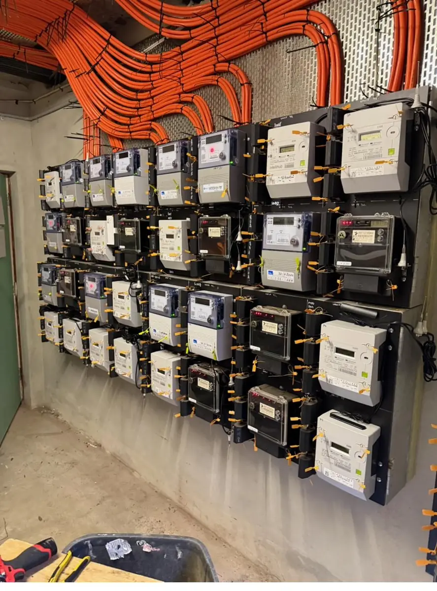 Wall of newly installed smart meters serving individual apartments